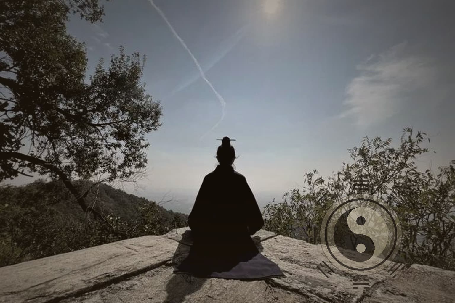 A Taoist practitioner seated from behind on a mountain rock, with a subtle taiji and bagua mark in the foreground.